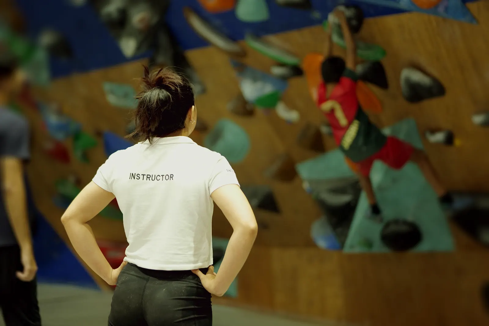 An Equilibrium instructor coaching a climber on the wall